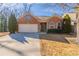 Brick ranch home with 2-car garage, landscaping, and a spacious driveway at 551 Garden View Ct, Lawrenceville, GA 30046