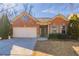 Brick ranch home with 2-car garage and mature landscaping at 551 Garden View Ct, Lawrenceville, GA 30046