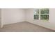 Bright bedroom with carpeted floor and large window at 1029 Blue Juniper Cir, Loganville, GA 30052