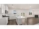 Spacious kitchen with white cabinets, island, and hardwood floors at 1029 Blue Juniper Cir, Loganville, GA 30052