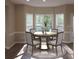 Bright dining room with a round table and four chairs, featuring large windows at 1240 Falls Creek Ct, Conyers, GA 30094