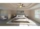 Spacious main bedroom with a large bed, featuring a ceiling fan and large window at 1240 Falls Creek Ct, Conyers, GA 30094