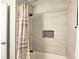 Updated bathroom with a shower/tub combo, tile surround, and modern fixtures at 4485 Spring Valley Pkwy, Atlanta, GA 30349