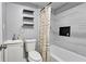 Clean bathroom with a shower/tub combo, floating shelves, and new vanity at 4485 Spring Valley Pkwy, Atlanta, GA 30349