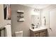 Updated bathroom with a single vanity, wood cabinets, and a sleek mirror at 4485 Spring Valley Pkwy, Atlanta, GA 30349