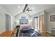 Main bedroom with a tufted headboard, large windows, and access to a private deck at 4485 Spring Valley Pkwy, Atlanta, GA 30349