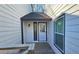 Front entrance with white door and sidelights, leading to a small wooden deck at 4485 Spring Valley Pkwy, Atlanta, GA 30349
