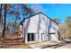 House exterior with a white-painted exterior, two-car garage, and large deck at 4485 Spring Valley Pkwy, Atlanta, GA 30349