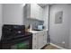 Basement kitchenette with microwave, stove, and white cabinets at 4485 Spring Valley Pkwy, Atlanta, GA 30349