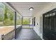 Charming front porch with gray wooden flooring and black railings at 1097 Charlie Sw Ln, Lilburn, GA 30047