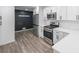 Modern kitchen with white cabinets, quartz countertops and stainless steel appliances at 1097 Charlie Sw Ln, Lilburn, GA 30047