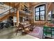 Spacious loft living area with exposed brick, high ceilings, and a modern aesthetic at 170 Boulevard Se # H-221, Atlanta, GA 30312