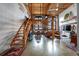 Open concept loft with exposed brick walls and wooden staircase at 170 Boulevard Se # H-221, Atlanta, GA 30312