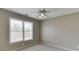 Well-lit bedroom with ceiling fan and large window with blinds at 2555 Lynshire Ln, Snellville, GA 30078