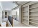 Upper-level hallway featuring built-in shelving and railing at 2555 Lynshire Ln, Snellville, GA 30078