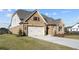 Two-story house with a large backyard and attached three-car garage at 2615 Yellowstone Farm Dr, Cumming, GA 30028