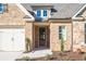 Inviting covered entryway with a charming front door and brick facade at 2615 Yellowstone Farm Dr, Cumming, GA 30028