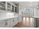 Butler's pantry with gray cabinets, quartz countertops and glass-front cabinets at 2615 Yellowstone Farm Dr, Cumming, GA 30028