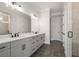 Double vanity bathroom with dark tile floors and a glass shower at 2615 Yellowstone Farm Dr, Cumming, GA 30028