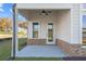 Covered patio with ceiling fan and brick accents at 2615 Yellowstone Farm Dr, Cumming, GA 30028