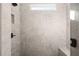 Large walk-in shower with gray tile and built-in seat at 2615 Yellowstone Farm Dr, Cumming, GA 30028