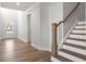 Elegant staircase with white risers and oak handrail in a light-filled entry at 2615 Yellowstone Farm Dr, Cumming, GA 30028
