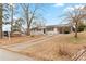 White brick ranch home with a long driveway and mature trees on a sloped lot at 1066 Cleavemark Dr, Clarkston, GA 30021