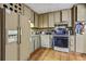 Small kitchen with beige cabinets and standard appliances at 2046 Kinridge Ct, Marietta, GA 30062