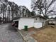 White carport with green trash bin, cars parked at 4411 Idlewood Ln, Tucker, GA 30084