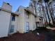 Tan colored siding townhouse with wooded backdrop at 4411 Idlewood Ln, Tucker, GA 30084