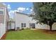 Fenced backyard features an enclosed porch and a tree for shade at 5140 Sky Ridge Way, Cumming, GA 30041