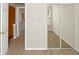 Carpeted bedroom with mirrored closet doors and light neutral paint at 5140 Sky Ridge Way, Cumming, GA 30041
