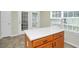 Kitchen island with white countertop and wood cabinets at 5140 Sky Ridge Way, Cumming, GA 30041