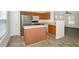 Bright eat-in kitchen featuring stainless steel appliances and an island, with view to living area at 5140 Sky Ridge Way, Cumming, GA 30041
