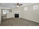 Cozy living room with fireplace and plush carpeting, bathed in natural light at 5140 Sky Ridge Way, Cumming, GA 30041