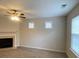 Inviting living area featuring a fireplace, neutral tones, and ample natural light at 5140 Sky Ridge Way, Cumming, GA 30041