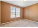 Simple bedroom with large window and neutral walls at 643 Rangeley Meadows Ct, Hampton, GA 30228