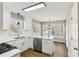 White kitchen with island, stainless steel appliances, and white cabinets at 1020 Wellers Ct, Roswell, GA 30076