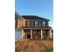 Two-story home with brick and siding, a front porch, and a landscaped yard at 221 Overlook Rd, Covington, GA 30014