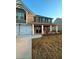 Two-story home with brick and siding, a front porch, and a landscaped yard at 221 Overlook Rd, Covington, GA 30014