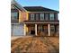 Two-story home with brick and siding, a front porch, and a landscaped yard at 221 Overlook Rd, Covington, GA 30014