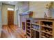 Inviting entry hall with hardwood floors, brick fireplace, and wine storage at 5143 Floyd Ne St, Covington, GA 30014