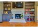 White brick fireplace with built-in shelving on either side at 5143 Floyd Ne St, Covington, GA 30014