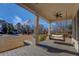 Relaxing front porch with a porch swing and ceiling fan at 5143 Floyd Ne St, Covington, GA 30014