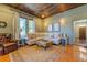 Cozy living room with hardwood floors, a sectional sofa, and wood ceiling at 5143 Floyd Ne St, Covington, GA 30014