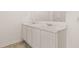 Bathroom vanity featuring double sinks with white cabinets and marble countertops at 8589 Seabiscuit Rd, Lithonia, GA 30058