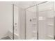 Bathroom featuring a shower over tub with sliding glass doors and neutral tones at 8589 Seabiscuit Rd, Lithonia, GA 30058