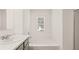 Clean bathroom featuring a large tub and shower at 8589 Seabiscuit Rd, Lithonia, GA 30058