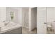 Bright bathroom with double sinks, sleek white shower and tile flooring at 8589 Seabiscuit Rd, Lithonia, GA 30058