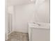 Bathroom featuring double sinks with white cabinets and marble countertops at 8589 Seabiscuit Rd, Lithonia, GA 30058